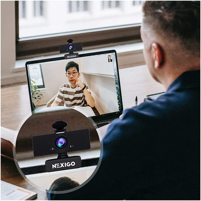 Shows the N60 webcam with privacy cover being clipped onto a laptop computer.